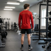 Red Christian fitness long sleeve shirt featuring a Spartan warrior lifting weights with Pray Eat Lift graphic and Kingdom Mindset Warrior Grind slogan.