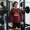 Cardinal red Christian long sleeve shirt featuring a Spartan warrior weightlifting graphic with Pray Eat Lift slogan and Kingdom Mindset Warrior Grind message.