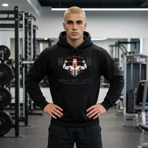 Black Christian fitness hoodie featuring a Spartan warrior lifting a barbell with the slogan "Pray Eat Lift" and faith-inspired strength training design.